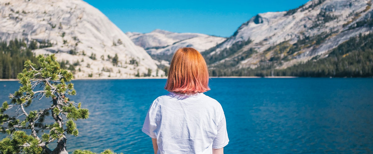 Girl sitting by the lake