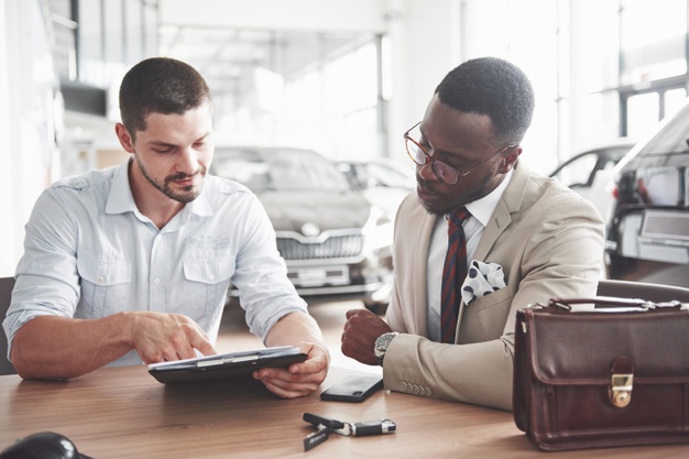 young-attractive-black-businessman-buys-new-car-he-signs-contract-takes-keys-manager