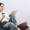 short-haired-girl-white-t-shirt-with-smile-reading-book-while-sitting-soft-bean-bag-2