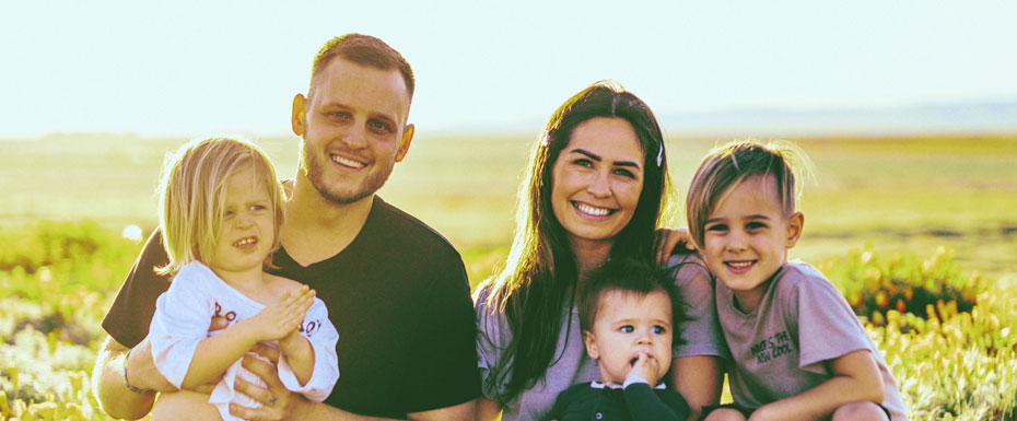 Happy Family Sitting in the seeds smiling on the sunrise