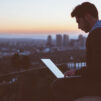 Freelancer sitting on the edge of the building working