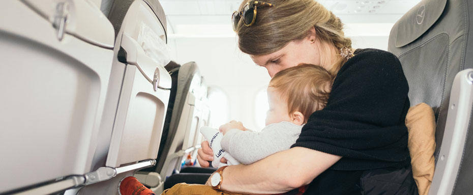 Woman holds baby in the airplane!