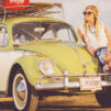 woman leaning on green and white Volkswagen Beetle near sea under white sky during daytime