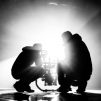 Grayscale photography of two crouching men making movie