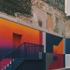 black, purple, and orange-basketball court beside concrete buildings at daytime