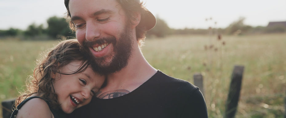 Man Carrying daughter in black sleeveless top