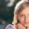 selective focus photography of girl in sequined-white and pink stripe shirt