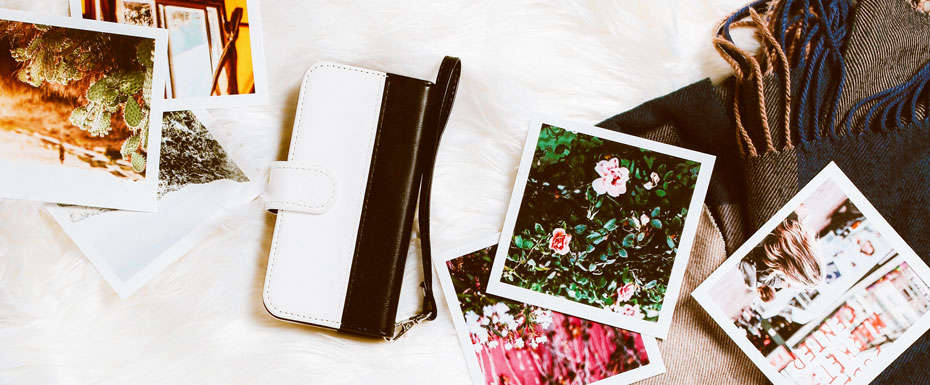 gold colored framed sunglasses on brown hat beside white and black leather wristlet surrounded-by-photos-on-white and gray floral textile