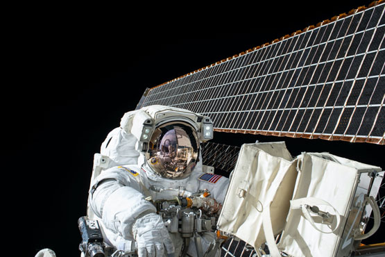 photography of Astronaut beside satellite