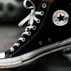 unpaired black and white high-top sneaker